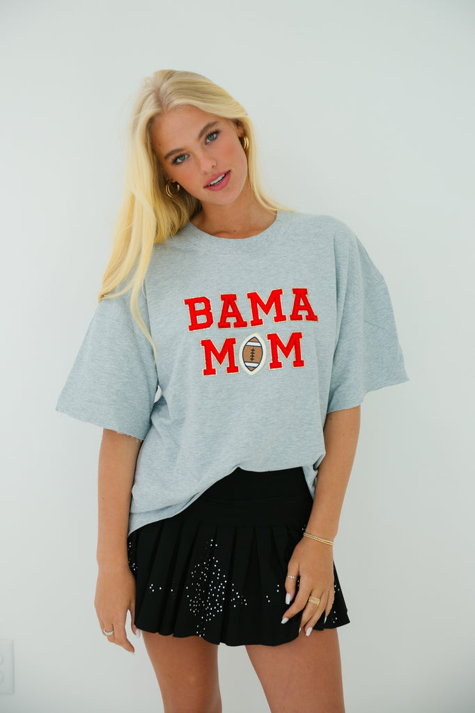 Grey t-shirt with Bama Mom in mini glam red letters and football patch