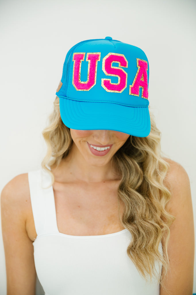 Blue trucker hat with pink "USA" letters