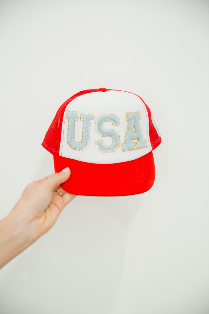 Kids red and white trucker hat with blue "USA" letters