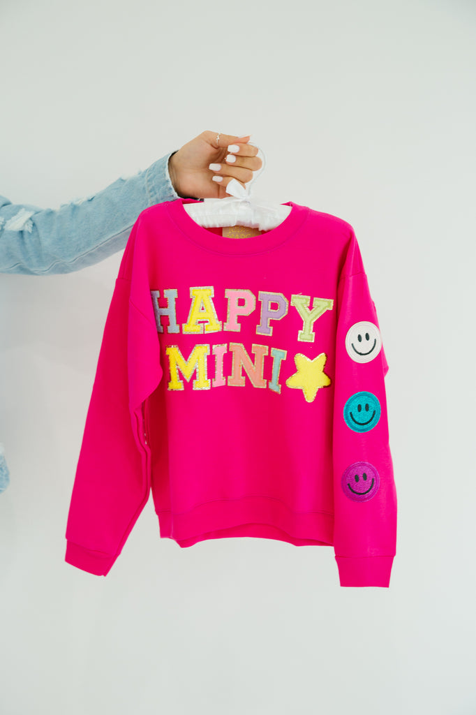 Kids hot pink pullover with "happy mini" in colorful mini terry lettering, colorful smiley patches, and a yellow terry star patch. 