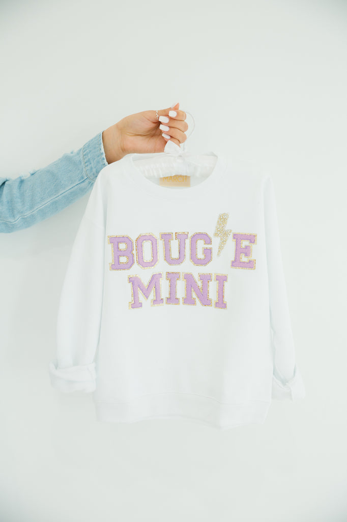 Kids white pullover with "bougie mini" in mini purple terry lettering and a rhinestone lightening bolt patch. 