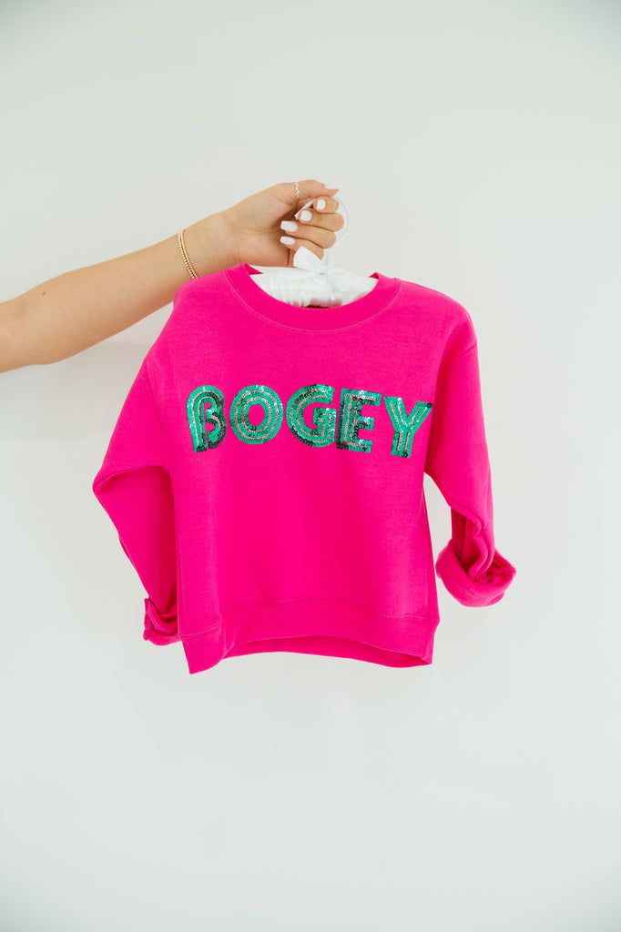 Kids hot pink pullover with "bogey" in green sequin lettering. 