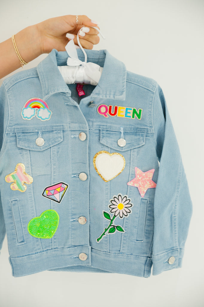Kids denim jacket with multiple fun and colorful patches. 
