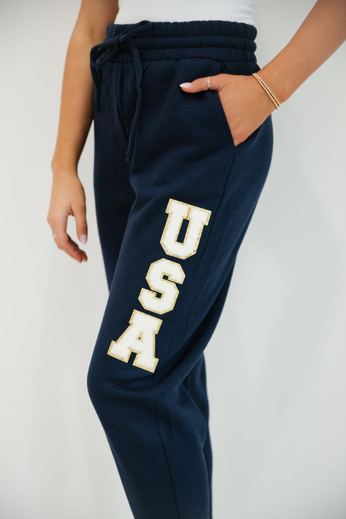 Navy sweatpants with white "USA" letters