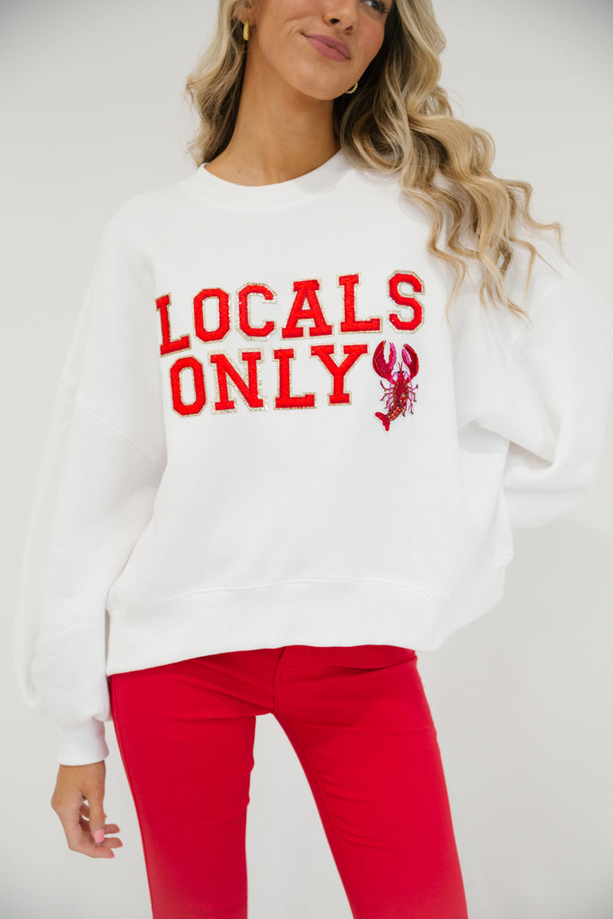 White cropped pullover with "Locals Only" in red letters with a lobster patch