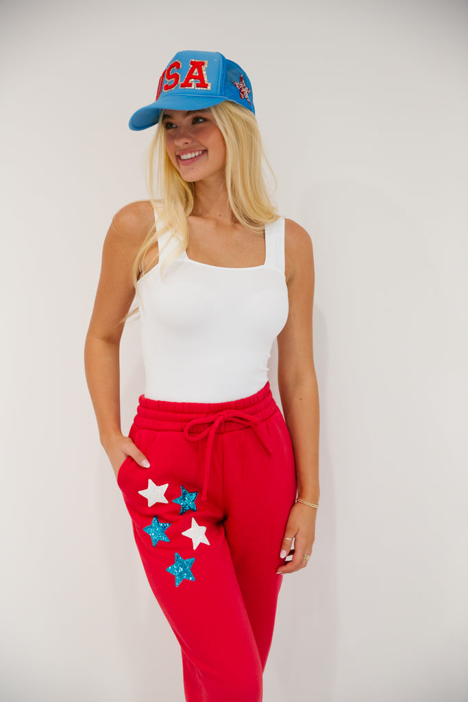 Red sweatpants with white and blue sequin stars