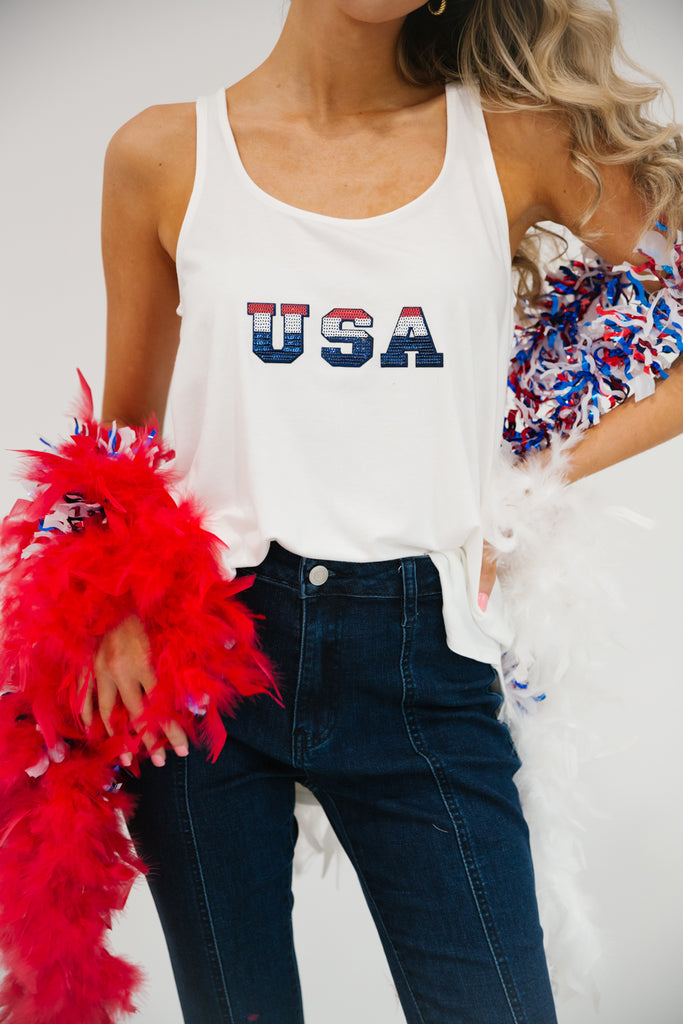 White scoop-neck tank top with red, white, and blue "USA" letters