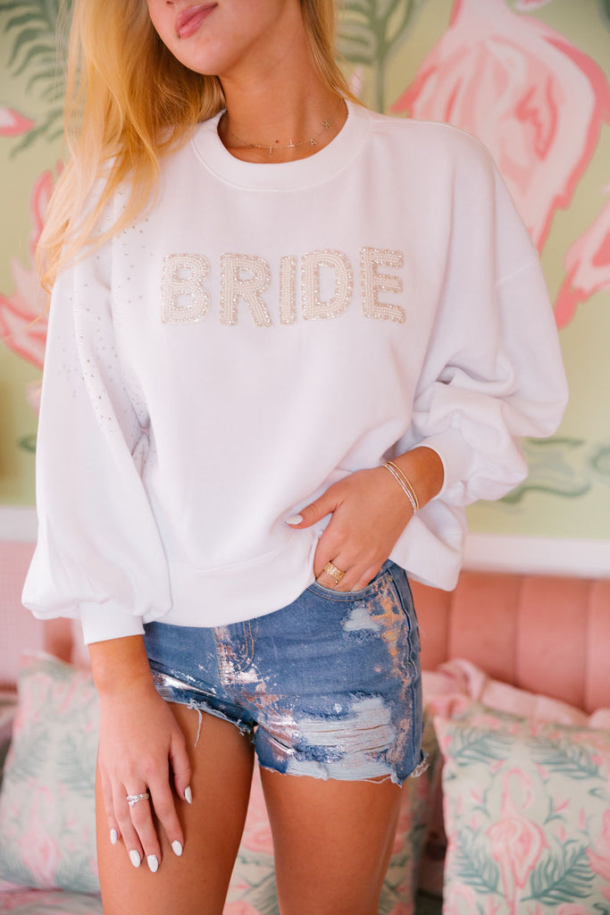 White cropped pullover with diamond accents and white beaded "bride" letters