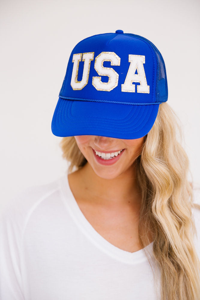 Royal blue trucker hat with white "USA" letters