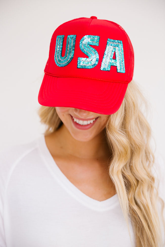 Red trucker hat with blue sequin "USA" letters