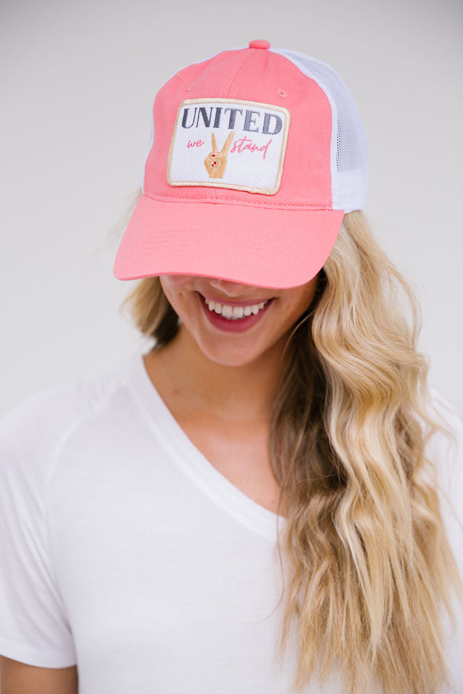 Pink baseball hat with "United We Stand" patch