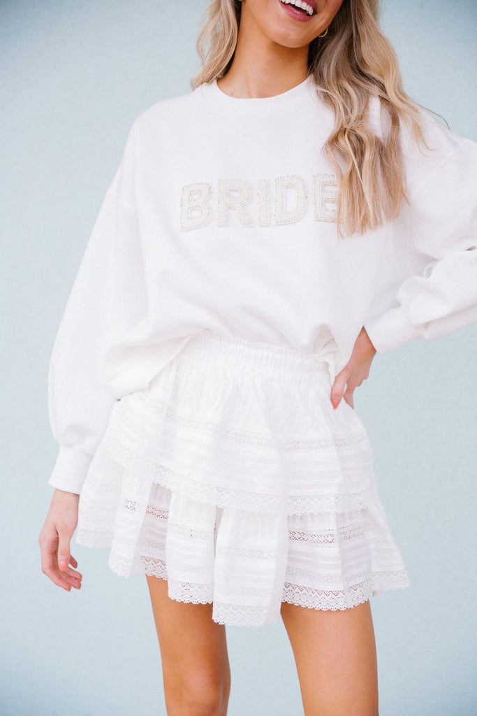 White cropped pullover with white beaded "Bride" letters