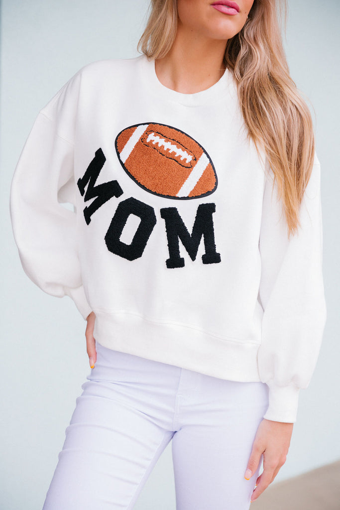 White cropped pullover with large football patch and Mom in black varsity letters