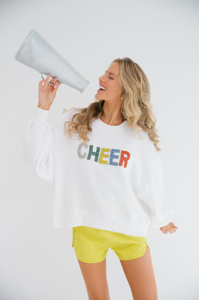 White cropped pullover with Cheer in rainbow diamond letters
