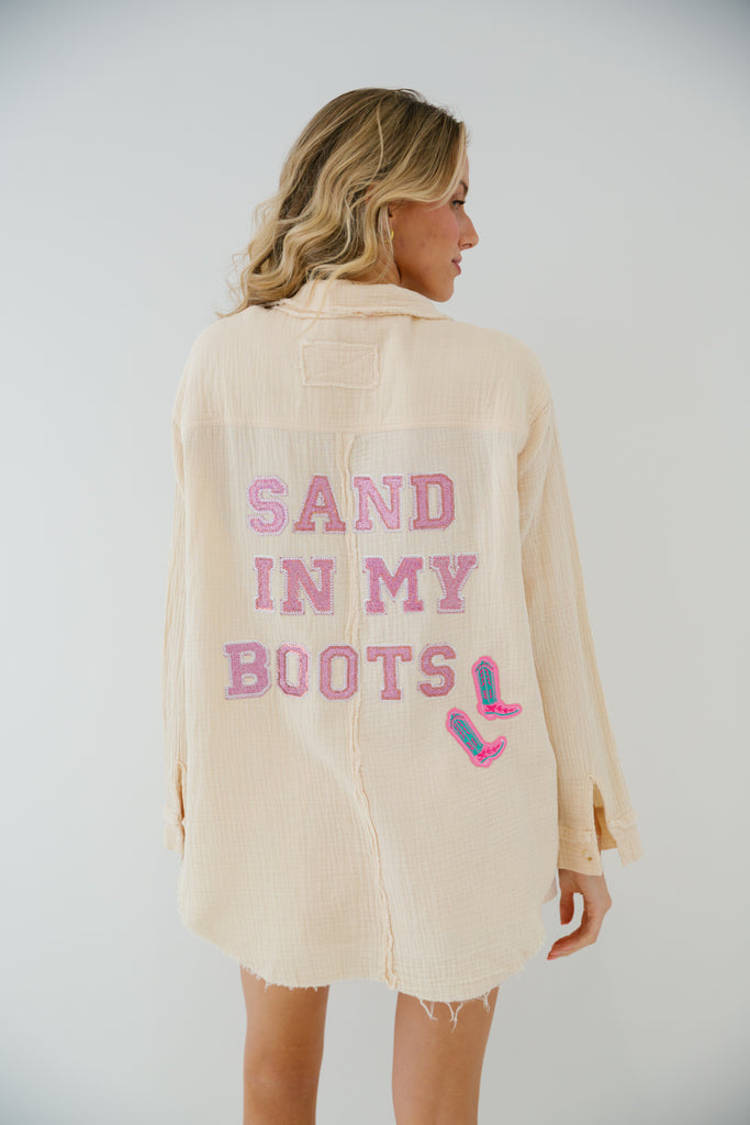 Cream button down with Sand In My Boots in pink sparkle letters with pink cowboy boot patches