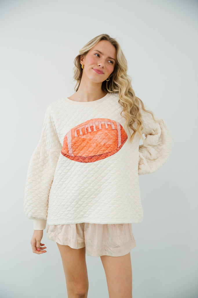 Cream quilted pullover with football print