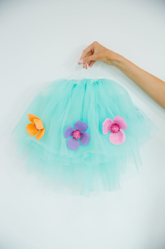 Blue tutu with flower patches. 