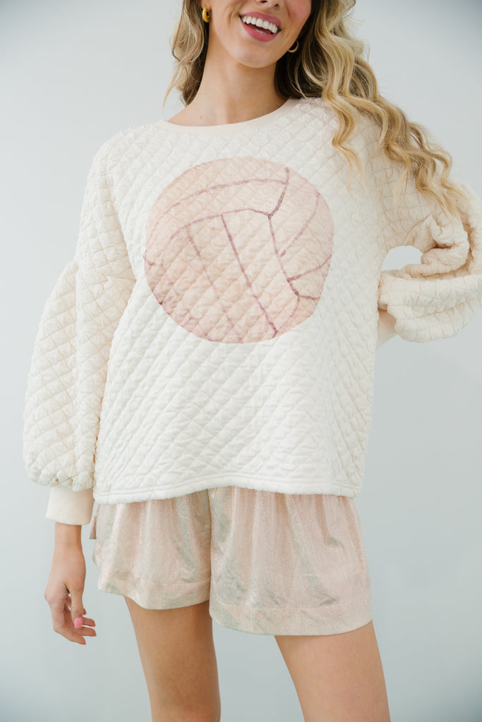 Cream quilted pullover with volleyball print