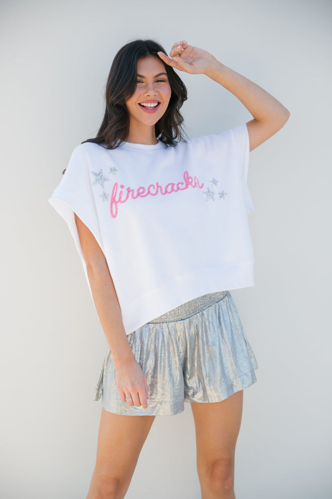 White short-sleeve top with silver stars and pink "Firecracker" print