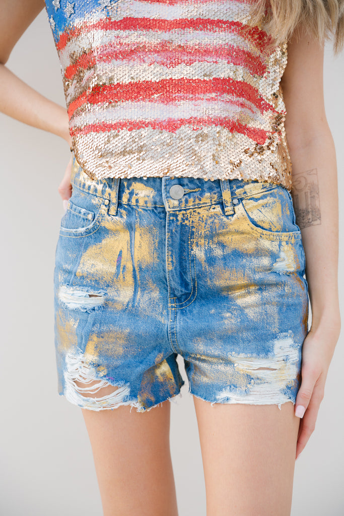 Denim distressed shorts with gold accents