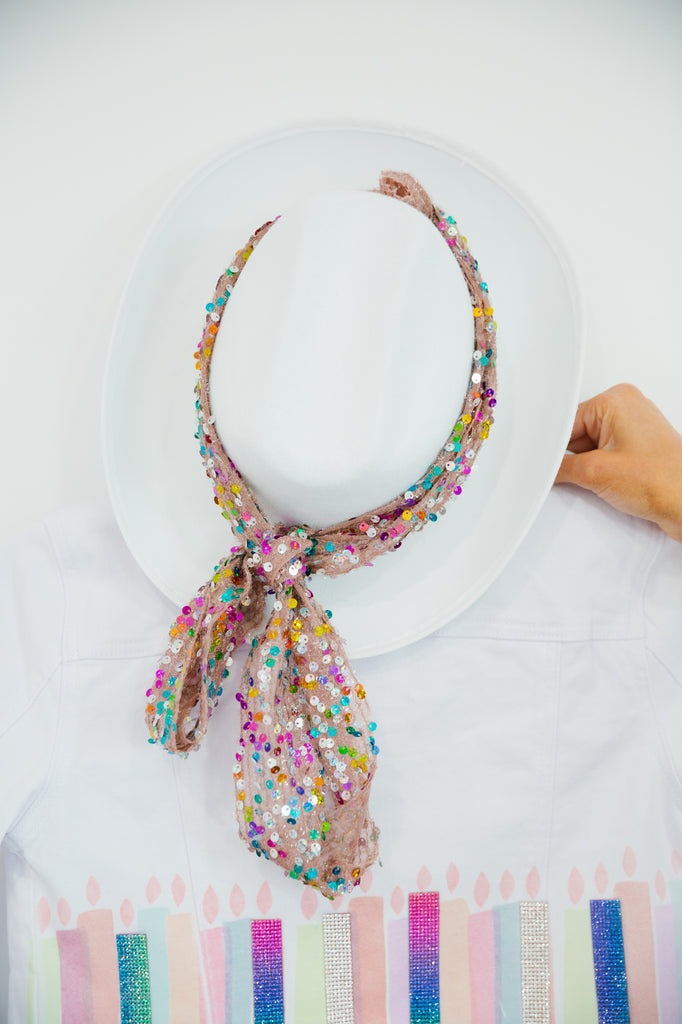 White rancher hat with a colorful sequin band. 