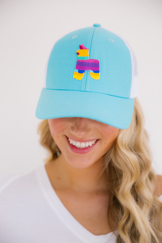 Turquoise baseball hat with a pinata patch